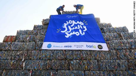 Environmental volunteers build a pyramid made of plastic waste collected from the Nile River, as part of an event to raise awareness about pollution in 