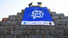Environmental volunteers build a pyramid made of plastic waste collected from the Nile as part of an event to raise awareness of pollution in 
