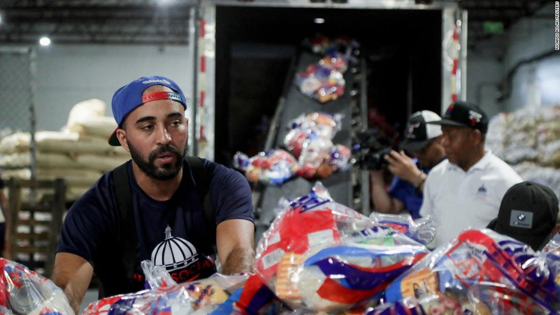 Workers of the Social State Plan prepare food rations in Santo Domingo, Dominican Republic, on Sunday.