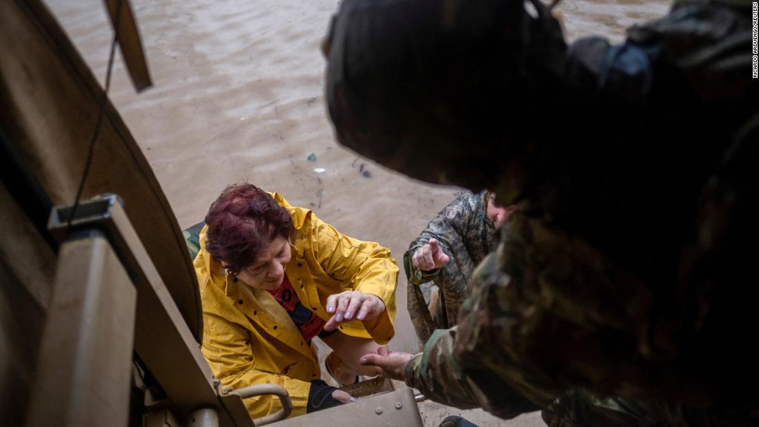 Members of the Puerto Rico National Guard rescue a woman stranded at her house in Salinas on Monday.