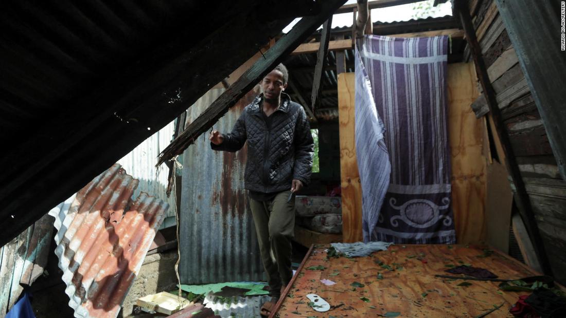 A man in El Seibo, Dominican Republic, looks at his damaged house on Tuesday.