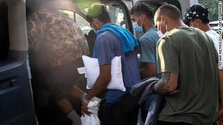 Migrants from Venezuela, who boarded a bus in Texas, wait to be taken to a local church by volunteers after being dropped off outside the residence of US Vice President Kamala Harris on September 15.