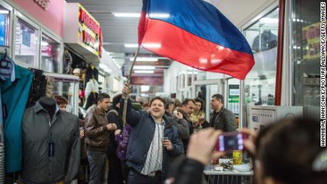 People celebrate the result of Crimea's referendum on joining Russia at a market in Simferopol, Ukraine, March 18, 2014.