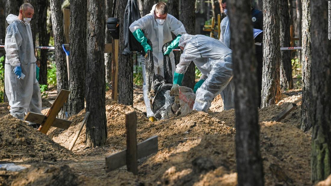 Forensic technicians operate at the site of a &lt;a href=&quot;https://edition.cnn.com/videos/politics/2022/09/18/ltg-on-war-crimes.cnn&quot; target=&quot;_blank&quot;&gt;mass grave in a forest&lt;/a&gt; on the outskirts of Izyum, eastern Ukraine on September 18. Ukrainian authorities discovered hundreds of graves outside the formerly Russian-occupied city.
