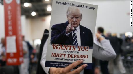 An attendee holds a sign in support of Matthew DePerno, the Republican nominee for Michigan attorney general, at a GOP convention in Grand Rapids, Michigan, on April 23, 2022.  