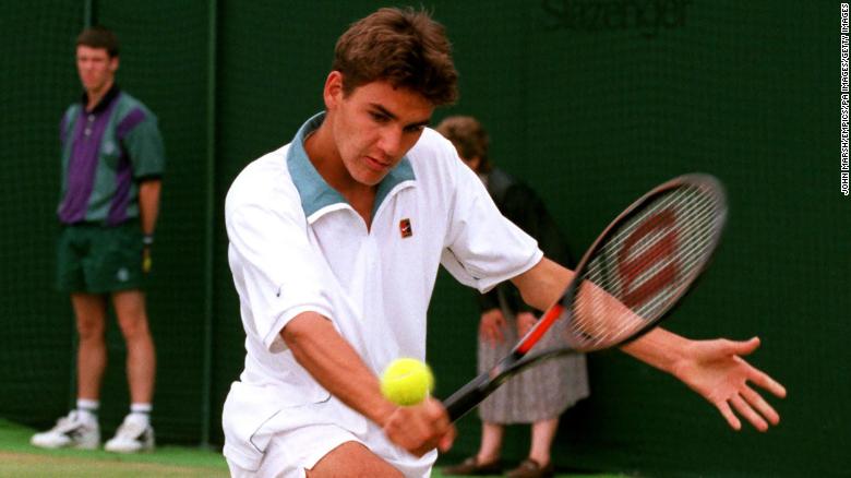 A teenage Federer hits a shot while on his way to winning the junior title at Wimbledon in 1998.