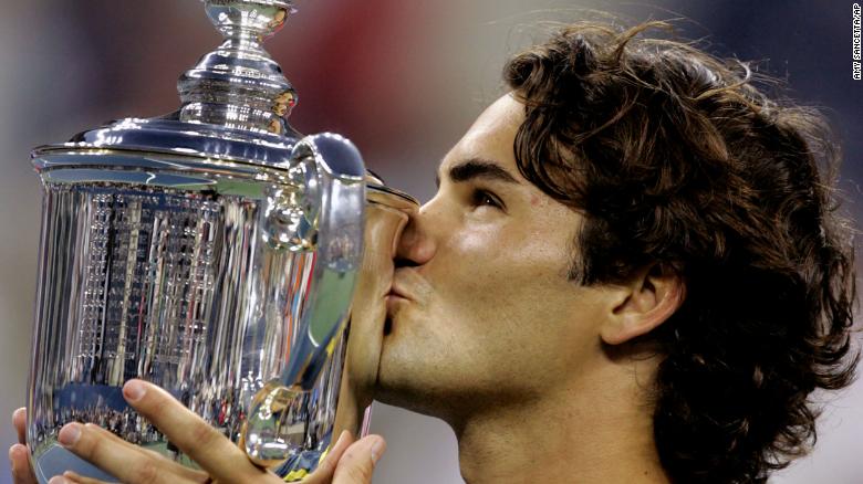 Federer kisses his trophy after he defeated Agassi to win the 2005 US Open.