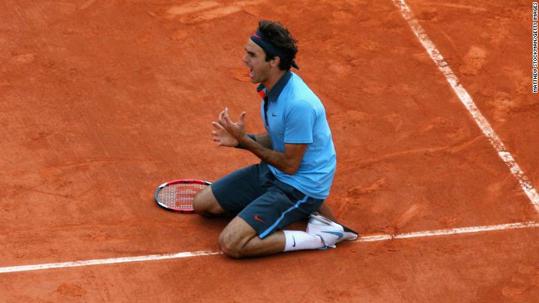 Federer falls to his knees after winning the French Open in 2009. The elusive title completed the career grand slam for Federer.