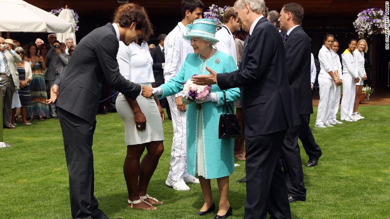 Federer greets Britain&#39;s Queen Elizabeth II while she attended Wimbledon in 2010.