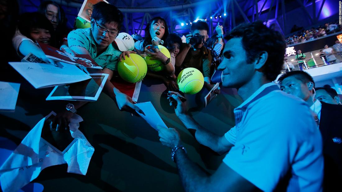Federer signs autographs for fans in Shanghai, China, in 2013.