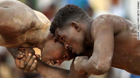 Competitors fight in a traditional Nuba wrestling match between the East Nile and Omdurman teams, at the Haj Youssef stadium in Sudan&#39;s Khartoum, on September 16.
