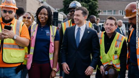 Transportation Secretary Pete Buttigieg, center, is seen during a press conference in Detroit earlier this month, touting infrastructure projects.