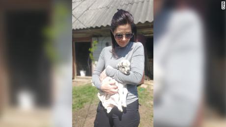 CNN&#39;s Erin Burnett holds a newborn goat in the Ukrainian town of Andriivka on May 11, 2022