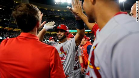 St. Louis Cardinals designated hitter Albert Pujols, center, celebrates with teammates after hitting a home run during the fourth inning of a baseball game against the Los Angeles Dodgers in Los Angeles, Friday, Sept. 23, 2022. It was Pujols&#39; 700th career home run. 