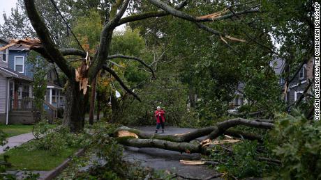 Georgina Scott surveys the damage on her street in Halifax on Saturday, September.  24, 2022  