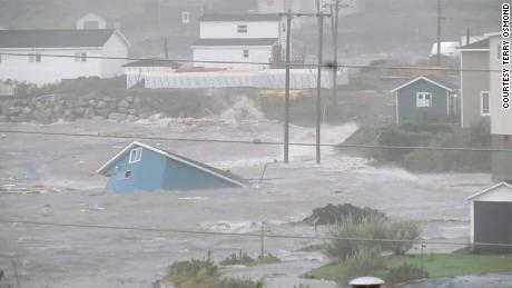 Water surrounds a collapsed house in Channel-Port aux Basque, Newfoundland, on Saturday. 