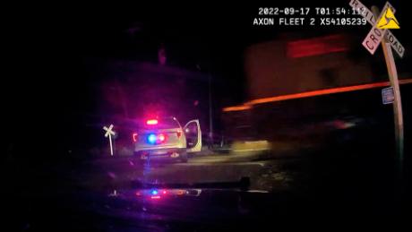 Dramatic video shows train plow into Colorado police car with woman handcuffed in back seat