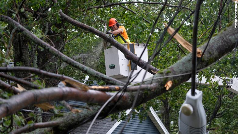 A worker clears fallen trees and downed wires from damage in Halifax on September 24, 2022.  