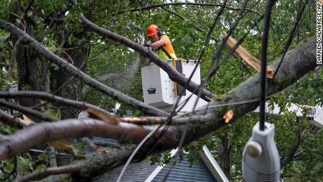 A worker clears damage from fallen trees and downed power lines in Halifax on September 24, 2022.  