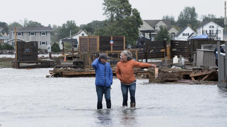 Residents stand in floodwaters following the passing of Fiona on Saturday in Shediac, New Brunswick.