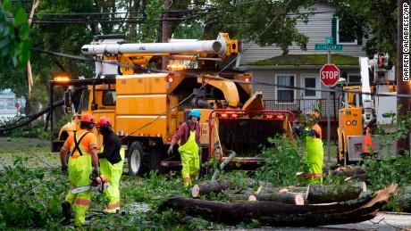 Workers clear fallen trees and downed wires from damage caused by post tropical storm Fiona in Halifax on Saturday, Sept. 24, 2022. 