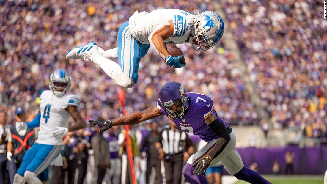 Who knew Lions could fly? Detroit wide receiver Amon-Ra St. Brown soars over Minnesota Vikings cornerback Patrick Peterson to pick up a first down at the two-yard line in the first quarter of their Week 3 clash. The Vikings won the game, 28-24, led by Kirk Cousins&#39; 260 yards passing and two TD tosses, to go to 2-1 on the year.