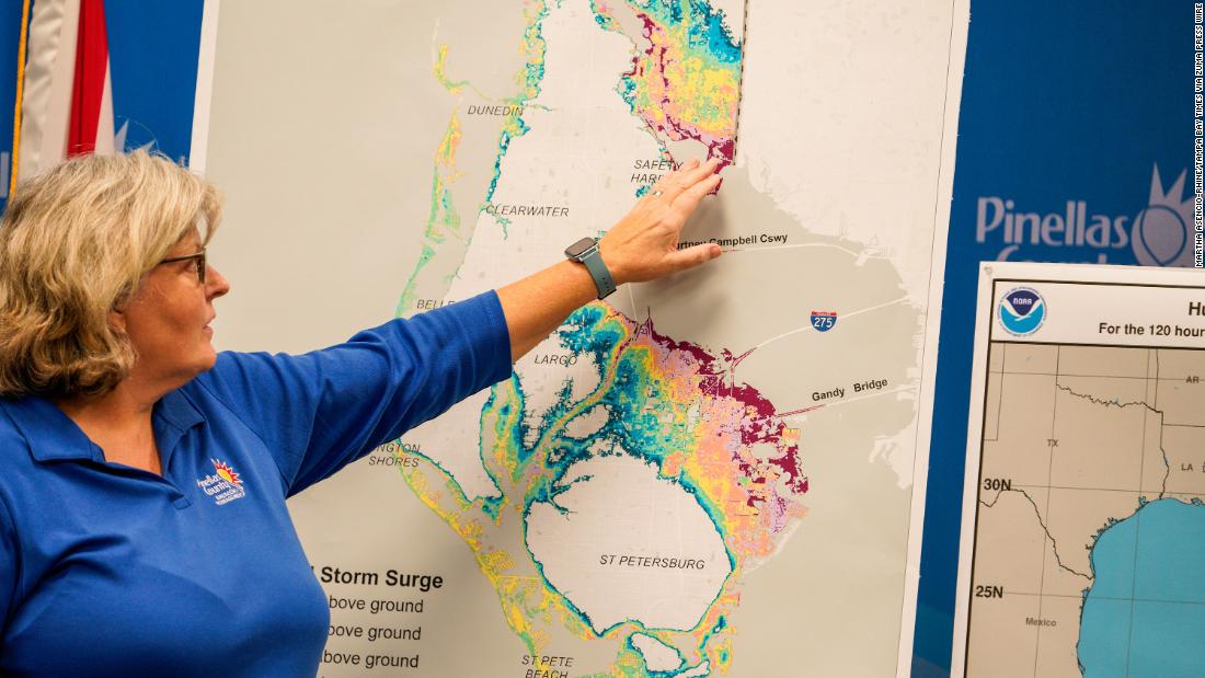 Cathie Perkins, emergency management director in Pinellas County, Florida, references a map Monday that indicates where storm surges would impact the county. During a news conference, she urged anyone living in those areas to evacuate.