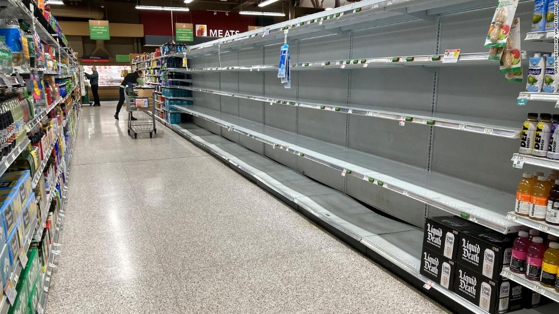 Shelves are empty in a supermarket&#39;s water aisle in Kissimmee on Monday.
