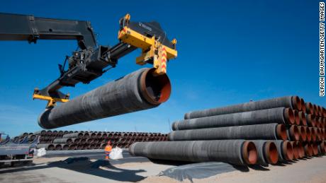 GERMANY, SASSNITZ - JUNE 05: Large pipes for the Baltic Sea pipeline Nord Stream 2 on a storage area in the ferry port of Sassnitz/Neu Mukran - Terminal Truck stacks the pipes. The pipes are sheathed with a concrete iron ore mixture. (Photo by Ulrich Baumgarten via Getty Images)