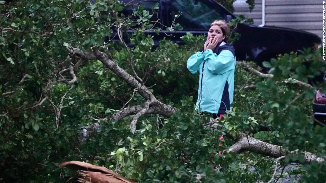 Zuram Rodriguez surveys the damage around her home in Davie, Florida, early on Wednesday.