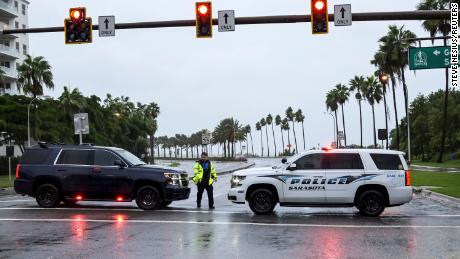Sarasota County Sheriff Deputies block the access to a downtown bridge over to the barrier islands as Hurricane Ian approaches Florida&#39;s Gulf Coast on September 28.