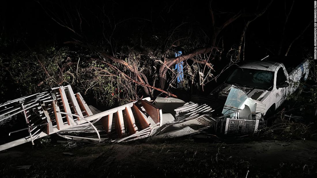 A spiral staircase lies next to a damaged pickup truck in Sanibel, Florida, on Thursday.