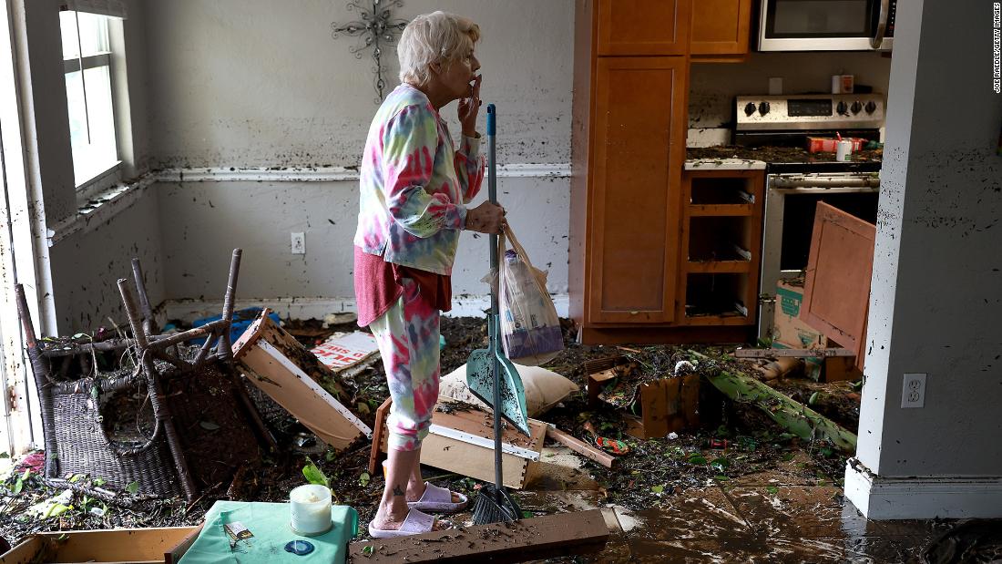 Stedi Scuderi looks over her flooded apartment in Fort Myers on Thursday.
