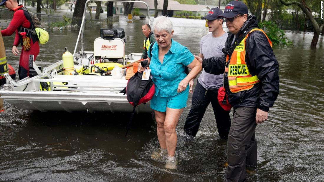 An Orlando resident is rescued from floodwaters on Thursday.