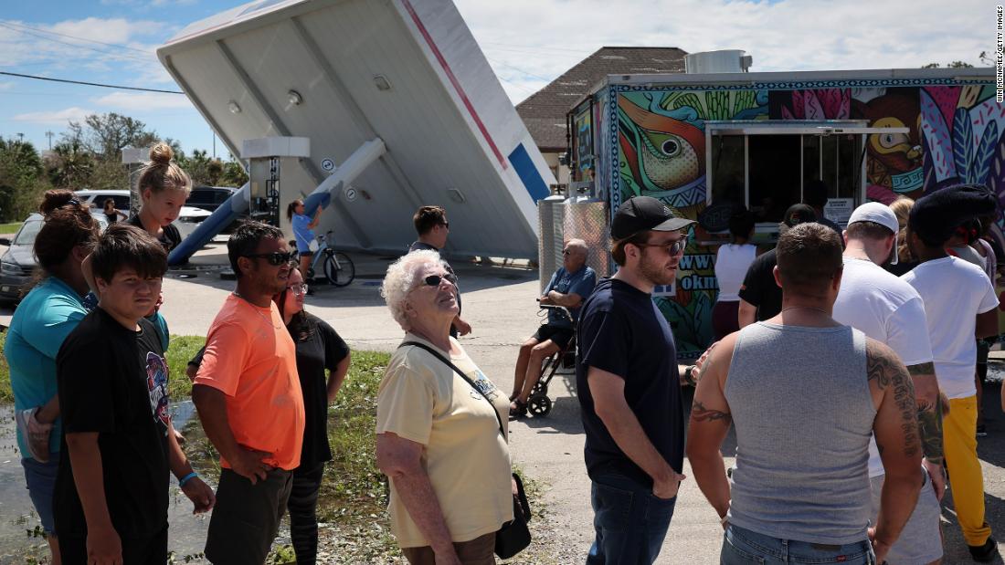 Residents of Port Charlotte, Florida, line up for free food that was being distributed from a taco truck on Thursday.