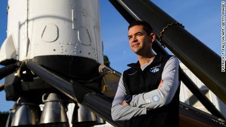 Inspiration4 mission commander Jared Isaacman, founder and chief executive officer of Shift4 Payments, stands for a portrait in front of the recovered first stage of a Falcon 9 rocket at Space Exploration Technologies Corp. (SpaceX) on February 2, 2021 in Hawthorne, California. - Isaacman&#39;s all-civilian Inspiration4 mission will raise $200 million for St. Jude Children&#39;s Research Hospital through a donation based sweepstakes to select a member of the crew. (Photo by Patrick T. FALLON / AFP) (Photo by PATRICK T. FALLON/AFP via Getty Images)