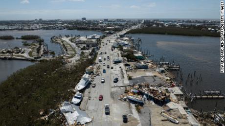 An aerial picture taken on September 29, 2022 shows washed up boats on a street in the aftermath of Hurricane Ian in Fort Myers, Florida. - Hurricane Ian left much of coastal southwest Florida in darkness early on Thursday, bringing &quot;catastrophic&quot; flooding that left officials readying a huge emergency response to a storm of rare intensity. The National Hurricane Center said the eye of the &quot;extremely dangerous&quot; hurricane made landfall just after 3:00 pm (1900 GMT) on the barrier island of Cayo Costa, west of the city of Fort Myers. 