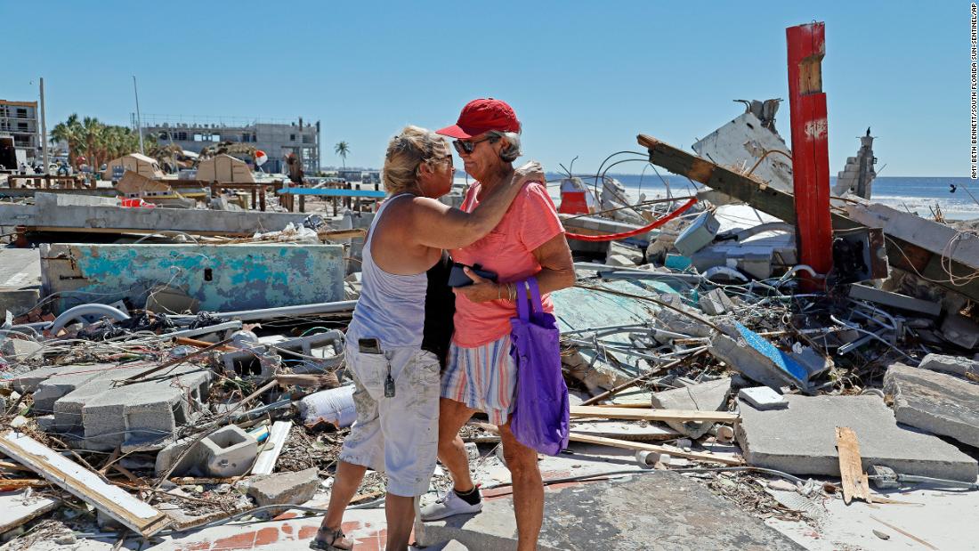 Local muralist Candy Miller, left, embraces Ana Kapel, the manager of the Pier Peddler, a gift shop that sold women&#39;s fashions, as she becomes emotional at the site where the store once stood on Fort Myers Beach on Friday.