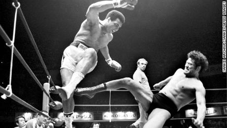 Boxer Muhammad Ali (L) fights with wrestler Antonio Inoki.