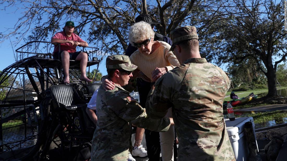 Members of the US Army National Guard help people evacuate from flood waters in North Port, Florida, on Friday, September 30.