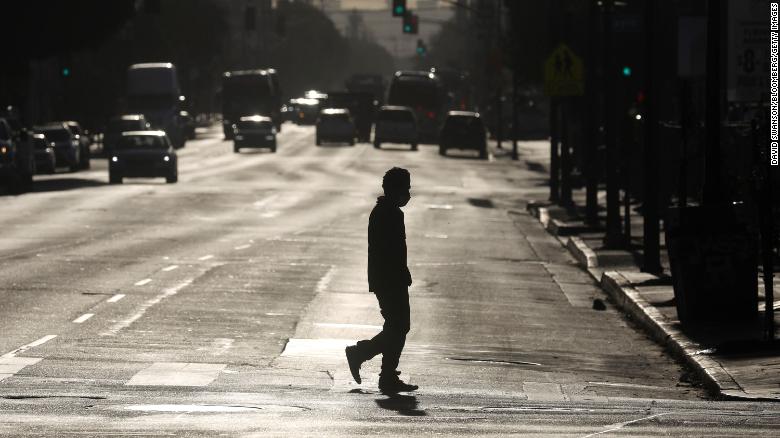 A pedestrian crosses a street in downtown Los Angeles, California, U.S., on Thursday, Dec. 3, 2020.