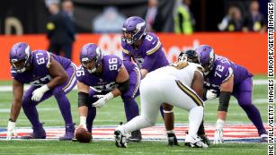 Minnesota Vikings quarterback Kirk Cousins (8) looks to hand off the ball  during an NFL match between Minnesota Vikings and New Orleans Saints at the  Tottenham Hotspur stadium in London, Sunday, Oct.