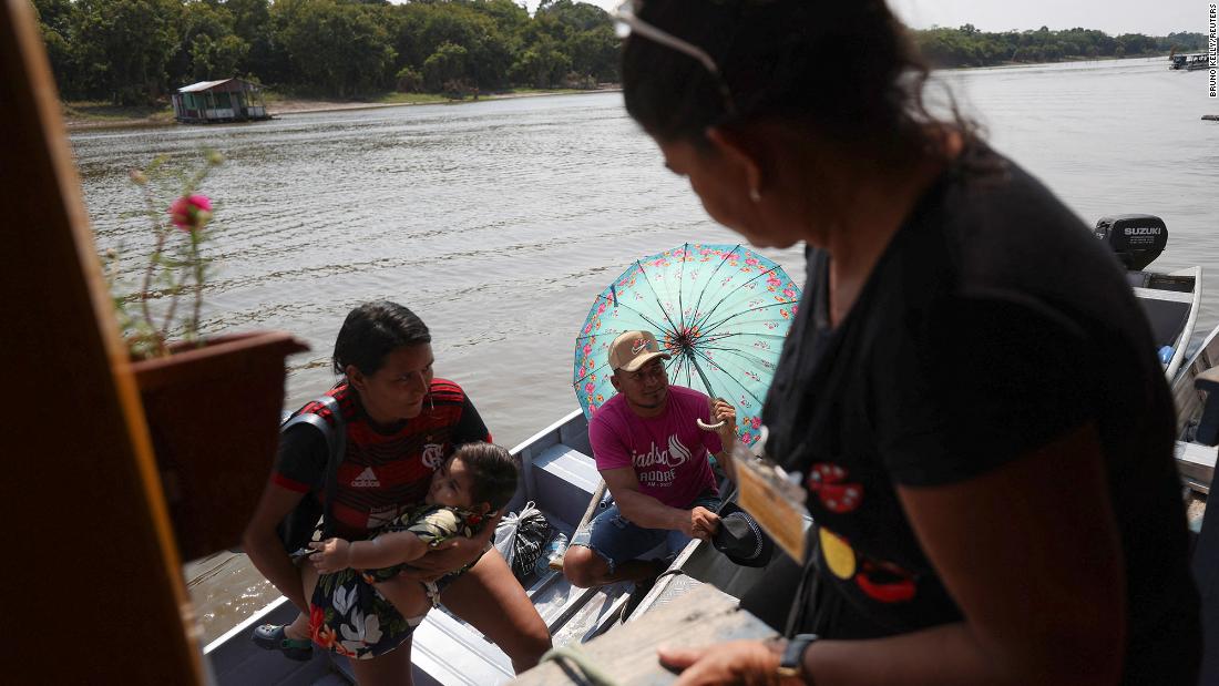 People arrive to cast their votes at a voting station set up on a floating school on the Negro River near Manaus, Brazil, on October 2.&lt;br /&gt;