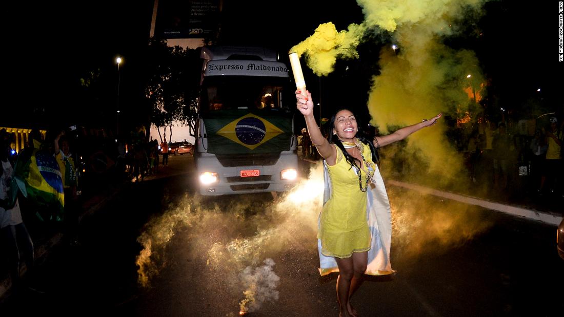 A Bolsonaro supporter celebrates the partial results after general election polls closed in Brasília on October 2.&lt;br /&gt;