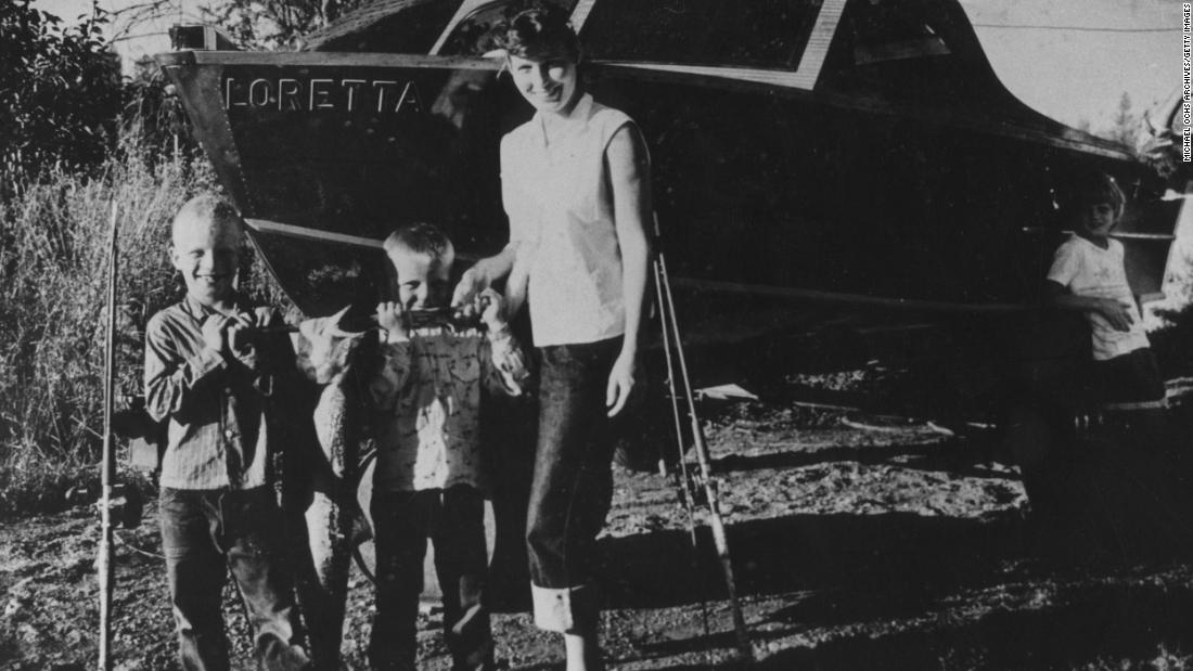 Lynn poses for a picture with three young boys in her hometown of Butcher Holler, Kentucky.