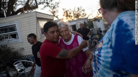 Carlos Hernandez hugs a neighbor in the aftermath of Hurricane Ian in Fort Myers Beach.