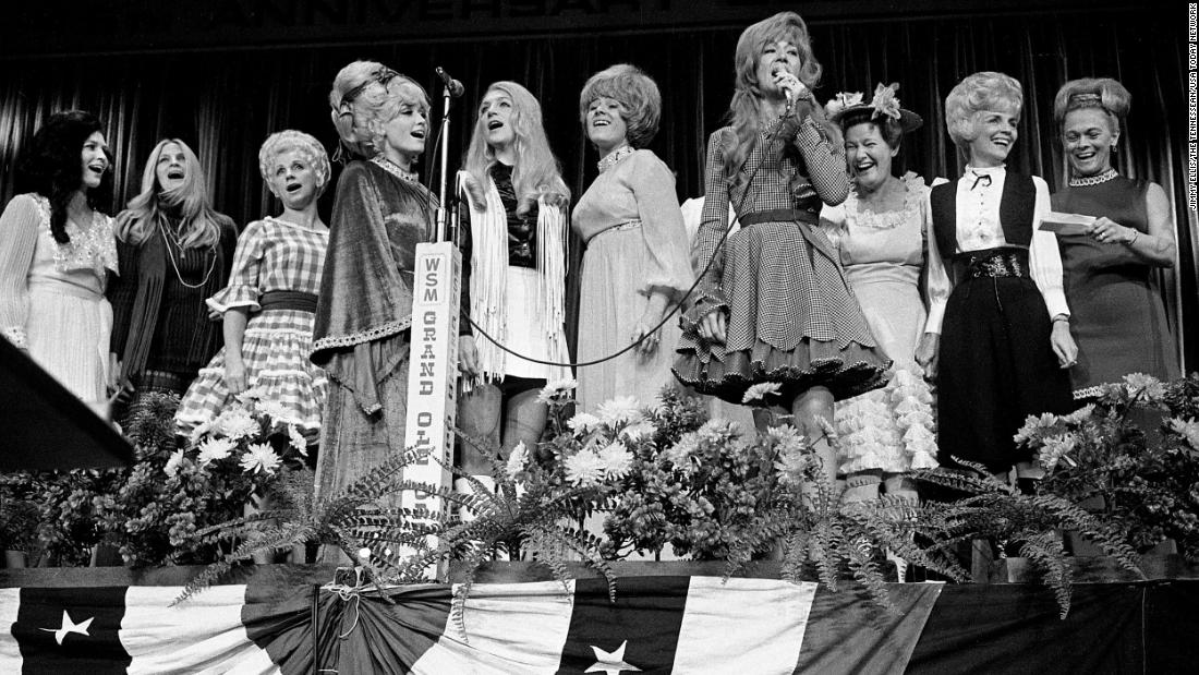 Lynn, left, joins fellow female country singers on stage as Dottie West, fourth from right, sings &quot;Born To Be A Country Girl&quot; at the Nashville Municipal Auditorium in 1970.