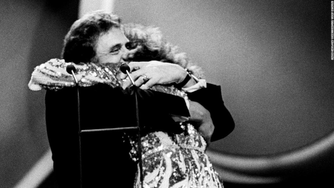 Johnny Cash welcomes Lynn into membership of the Country Music Hall of Fame during the 1988 CMA Awards at the Grand Ole Opry in Nashville. 
