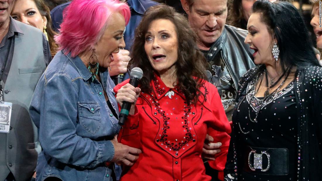 From left, Tanya Tucker, Lynn and Crystal Gayle perform at Lynn&#39;s 87th birthday tribute at Bridgestone Arena in Nashville in 2019.