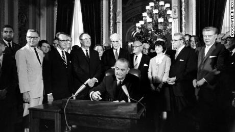 President Lyndon Johnson signs the Voting Rights Act of 1965 in a ceremony in the President&#39;s Room near the Senate chambers.